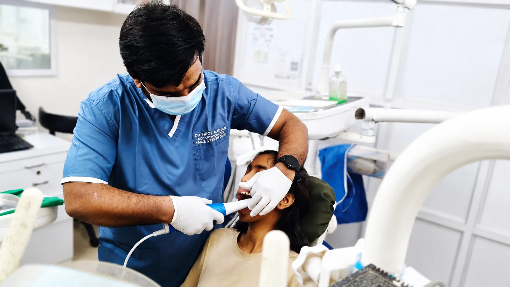 Dr. Firoz A. Khan treating a patient at Smile & Teeth Care